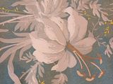 a close up of a painting of flowers on a wall