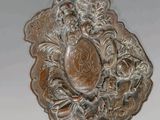 un plateau en argent orné d'une fleur, posé sur une table