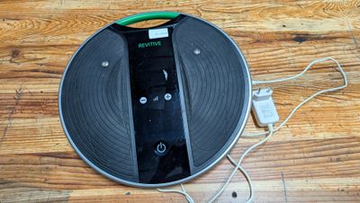 a remote control on a record on a wooden floor