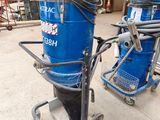 two vacuums that are on a cart in the garage