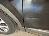a close up of a car ' s tire on the side of the road