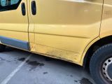 a yellow van parked in a parking lot next to a building