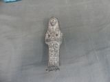 a statue of an egyptian woman on a gray cloth