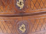 a wooden chest of drawers with a clock on top of it