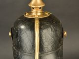 an image of a black and gold vase with a gold top