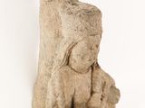 statue of a woman sitting on a rock with a baby in her lap