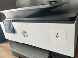 a printer sitting on top of a wooden table next to a printer