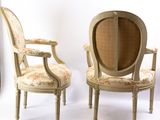 two chairs with floral upholstered upholstered back and arms