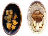two oval gold broochees with flowers in them