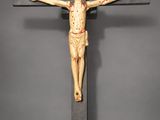 wooden crucifix with jesus on the cross on a gray background