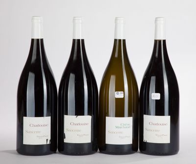 four bottles of wine are lined up in a row on a table