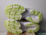 the soles of a pair of running shoes on top of a cardboard box