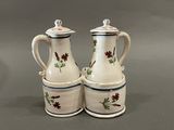 two white and blue vases with red flowers on them