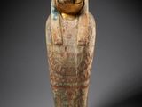 an egyptian painted wooden statue of a woman