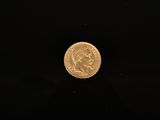 a gold coin on a black background