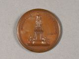 a coin with a statue on it sitting on a table