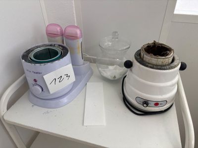 a blender sitting on a small table with a cup of coffee
