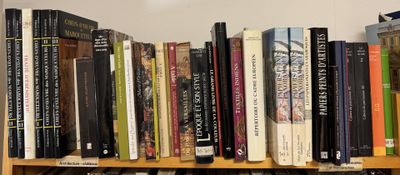 many books that are on a shelf in the room