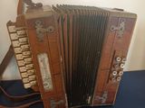 an old wooden accordion sitting on a blue surface