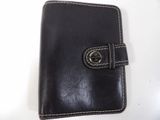 a black leather wallet with a metal clasp on it