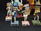 many figurines of cartoon characters displayed on a table