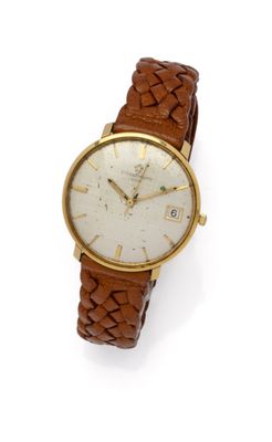 a close up of a wrist watch on a white surface