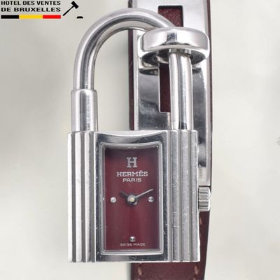 a red watch with a padlock attached to it