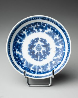 a blue and white plate with a circular design on it
