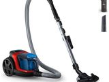 a red and blue vacuum cleaner with a black handle