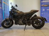 motorcycle parked in a showroom in front of a display wall