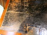 a dirty floor with a metal plate on it