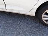 a white car that is parked on the side of the road