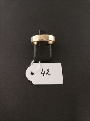 a gold ring with a price tag attached to it