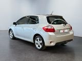 the back of a white toyota yaris parked in a white room