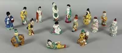 many figurines of asian women and men in a circle