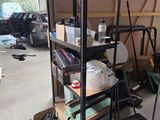 a television sitting on a shelf in a garage