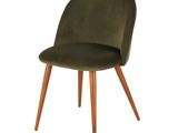 the chair is made of wood and has a green velvet upholstered seat