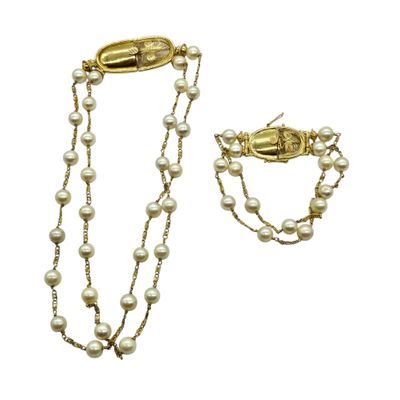 a close up of a necklace and bracelet with pearls on a white background