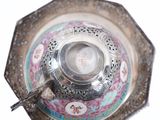 a silver plate with a picture of a woman on it
