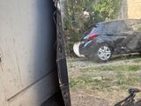 a broken mirror sitting on the ground next to a car