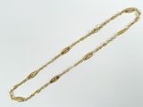 a close up of a gold chain on a white background