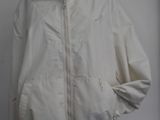 jacket on a mannequin stand with a white wall in the background
