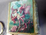 a box with a picture of a fairy on it and a pair of scissors next to it