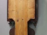 a wooden clock hanging on the wall in the room