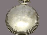 an antique silver pocket watch with a chain on the front