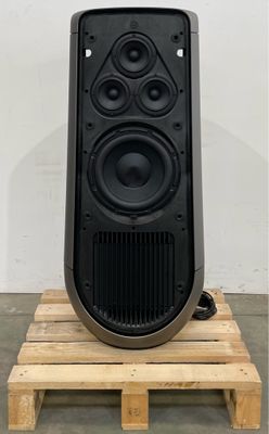 a black speaker sitting on top of a wooden pallet