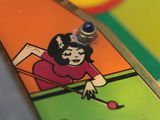 a close up of a pinball game on the table