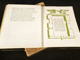 an open book with a picture on it on a table