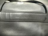 black leather handbag with the name of a man on it