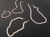 a collection of pearl necklaces, bracelets and broocher